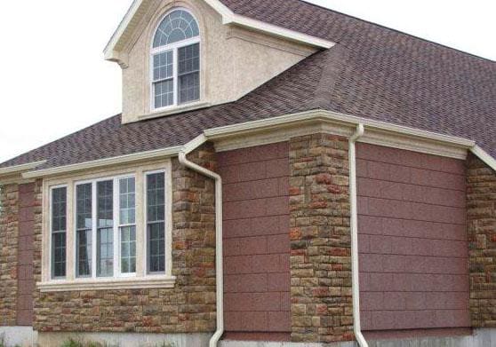 Gable and eave detail where synthetic stone meets the wall above