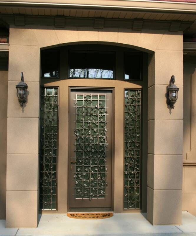 Recessed entry with an arched head, stucco pilasters and glass-block sidelights