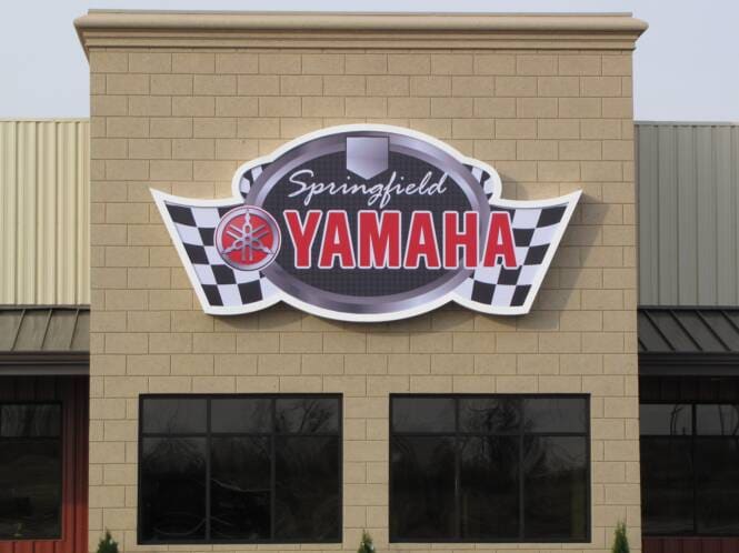 Powersports dealership storefront with a stucco parapet and sign band