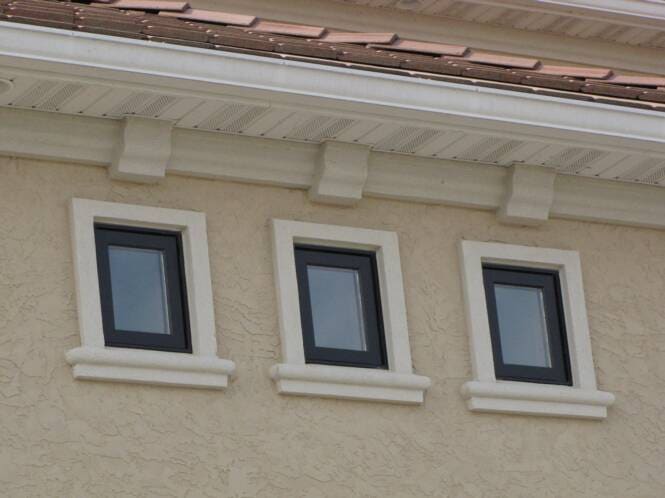 Window sills and corbels below a tile-roof eave
