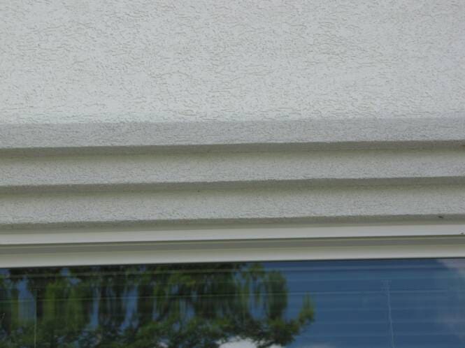Layered cornice banding above a window head
