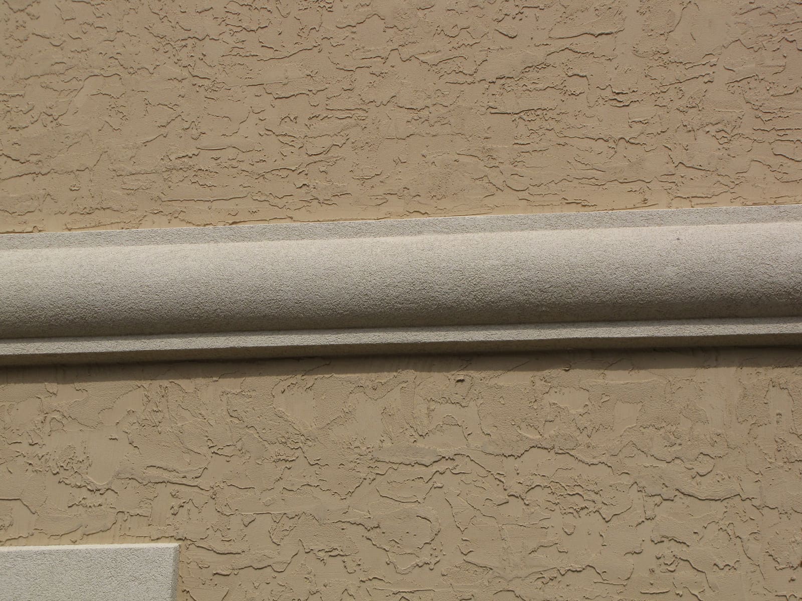 Close-up of a heavy troweled texture beneath a trim band
