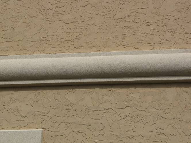 Trim band running across a heavily textured wall