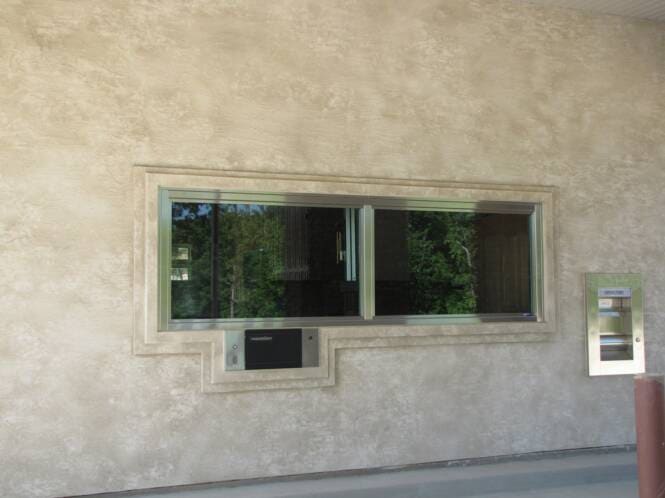 Window opening trimmed with a stucco band and reveal