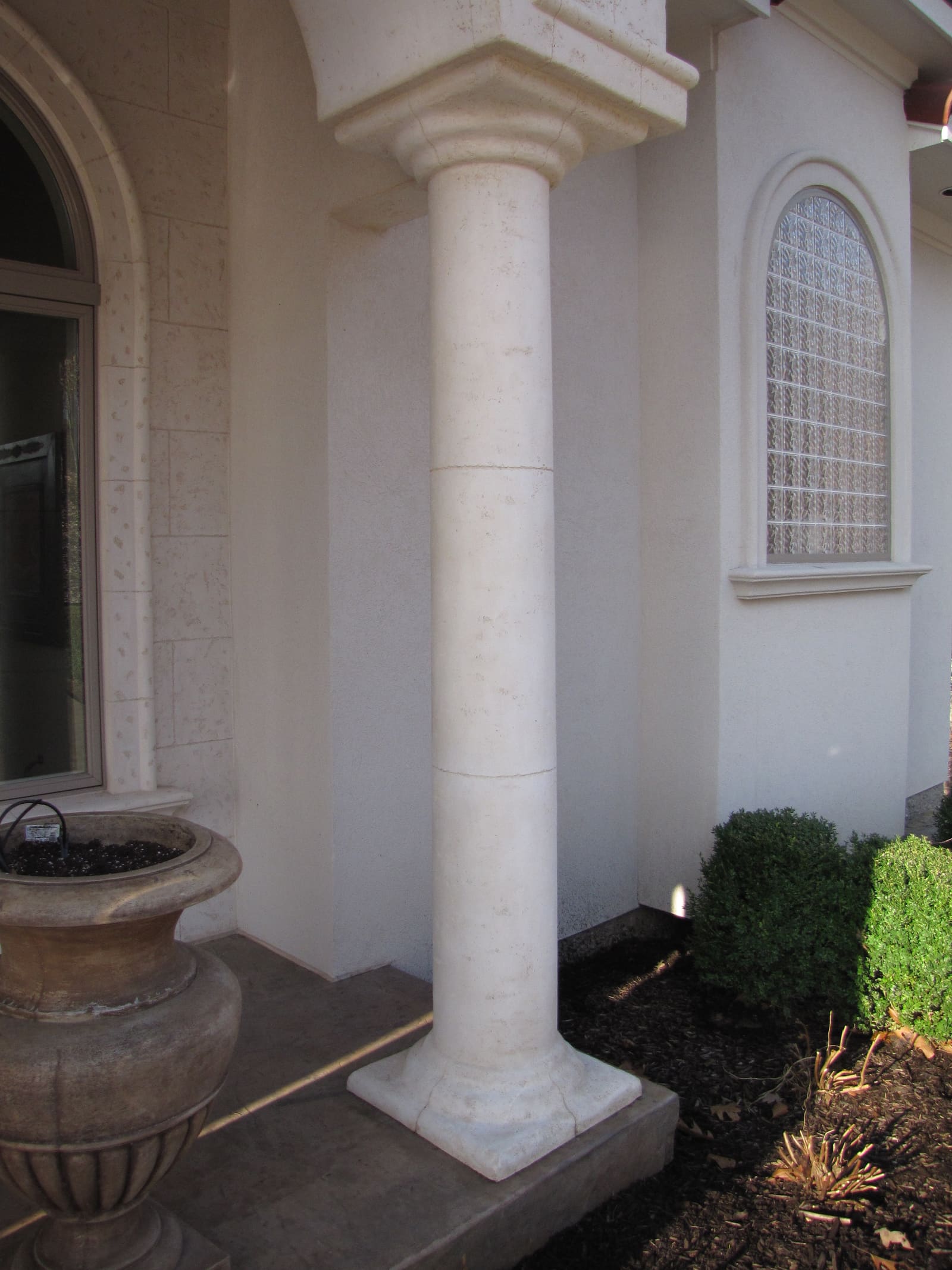 Entry column beside an arched window head